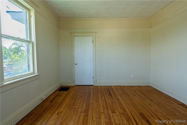 89 N Main St, Kilmarnock, VA 22482 - spare room with ornamental molding, hardwood / wood-style floors, and baseboards