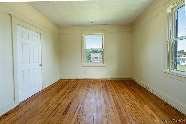 89 N Main St, Kilmarnock, VA 22482 - empty room featuring plenty of natural light, wood-type flooring, baseboards, and ornamental molding