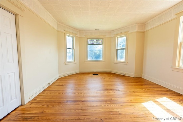 89 N Main St, Kilmarnock, VA 22482 - spare room featuring light wood-style floors, baseboards, and ornamental molding