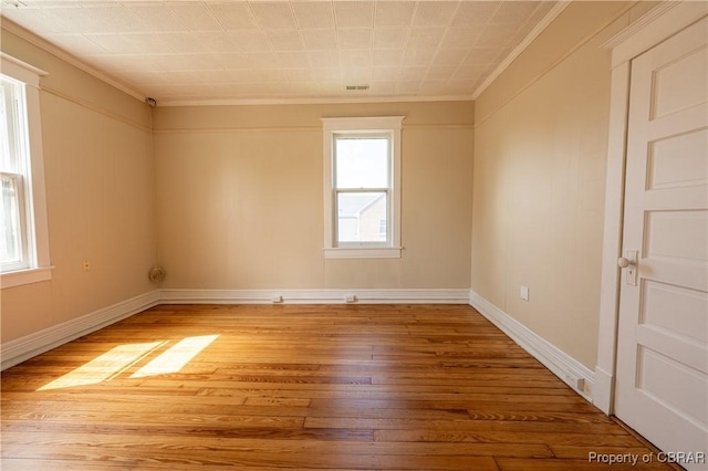 89 N Main St, Kilmarnock, VA 22482 - spare room featuring crown molding, light wood finished floors, and baseboards