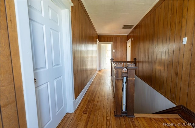 89 N Main St, Kilmarnock, VA 22482 - hall featuring an upstairs landing, wooden walls, wood finished floors, and baseboards