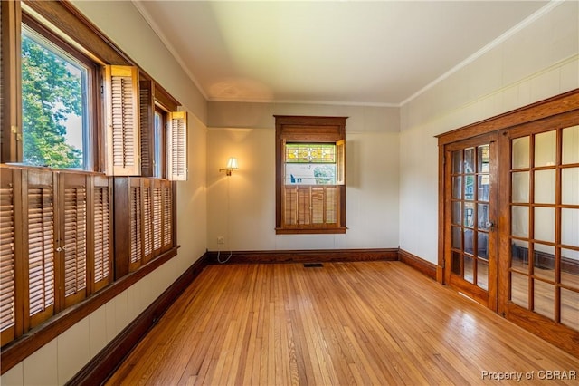 89 N Main St, Kilmarnock, VA 22482 - spare room featuring baseboards, hardwood / wood-style floors, and ornamental molding