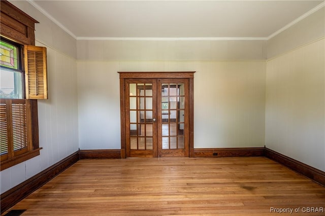 89 N Main St, Kilmarnock, VA 22482 - empty room with wood finished floors, baseboards, crown molding, and plenty of natural light