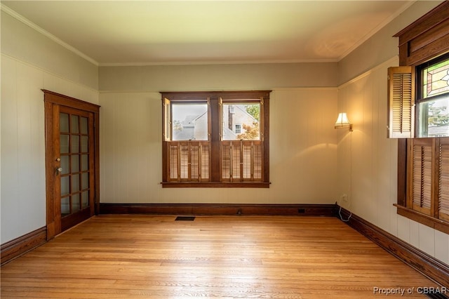 89 N Main St, Kilmarnock, VA 22482 - empty room with light wood-style floors, crown molding, and baseboards
