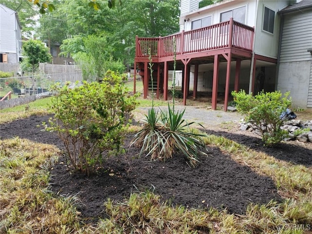 view of yard with a wooden deck and fence