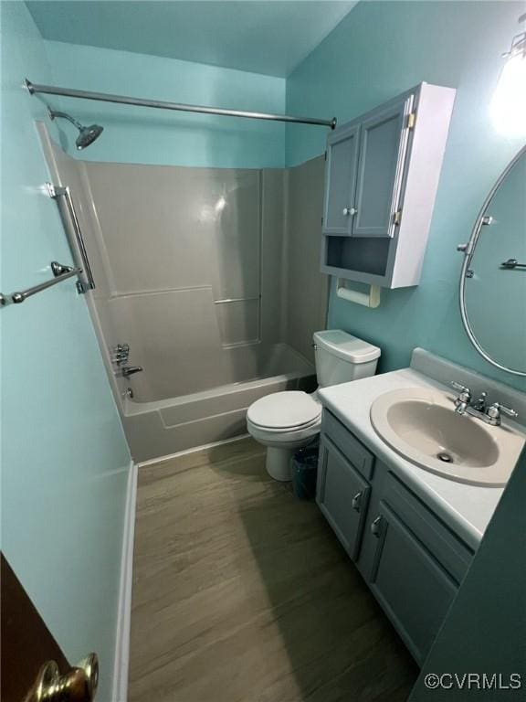 full bathroom featuring wood finished floors, vanity, toilet, and shower / bathtub combination