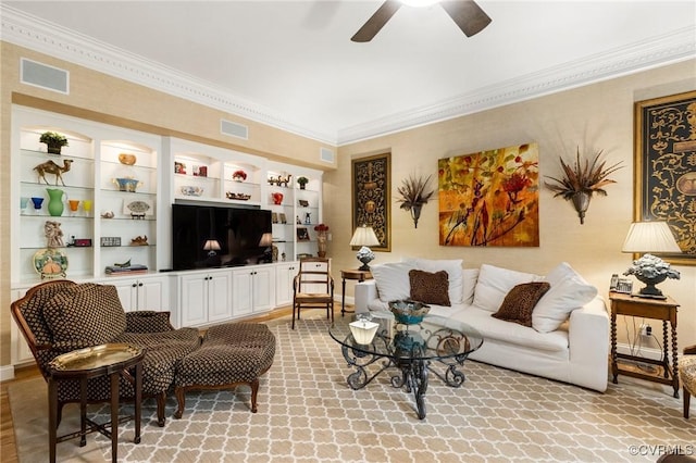 living area featuring ornamental molding and ceiling fan