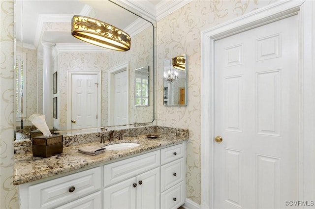 bathroom featuring wallpapered walls, ornamental molding, and vanity