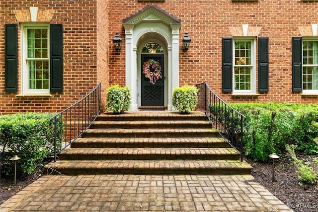 view of exterior entry with brick siding