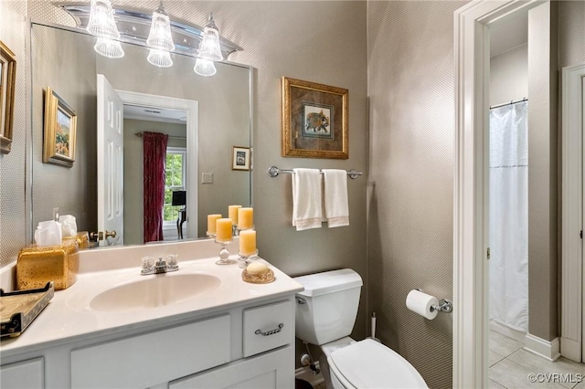 bathroom with vanity, toilet, and tile patterned flooring