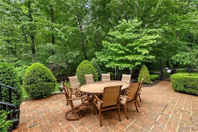 view of patio featuring fence and outdoor dining space