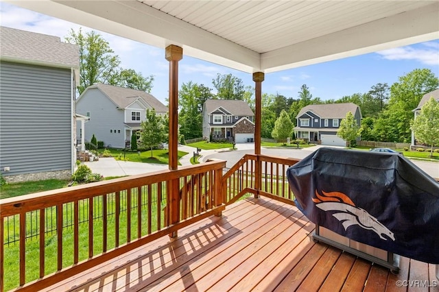wooden terrace with a residential view, a porch, area for grilling, and a yard