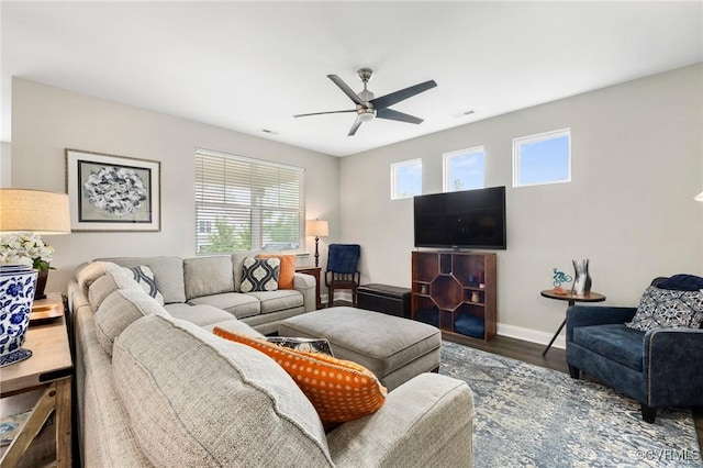 living area featuring ceiling fan, wood finished floors, and baseboards