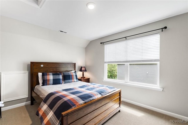 bedroom featuring carpet floors, baseboards, and vaulted ceiling