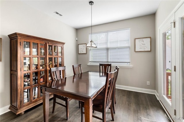 dining area featuring dark wood-style floors and baseboards