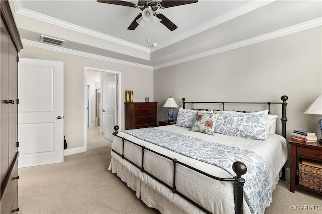 bedroom with light carpet, crown molding, baseboards, a ceiling fan, and a tray ceiling