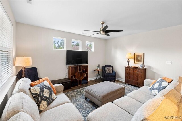 living area with ceiling fan, baseboards, and wood finished floors