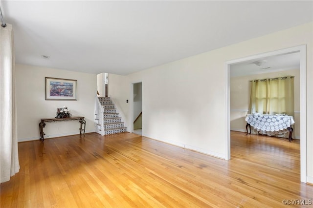 10970 Haverford Ln, North Chesterfield, VA 23236 - empty room with light wood finished floors and stairway