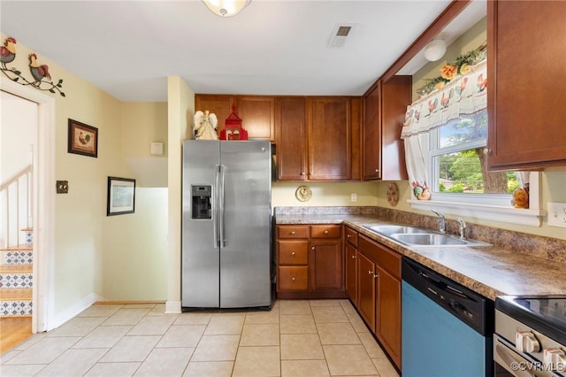 10970 Haverford Ln, North Chesterfield, VA 23236 - kitchen featuring stainless steel appliances, a sink, light tile patterned floors, and brown cabinetry