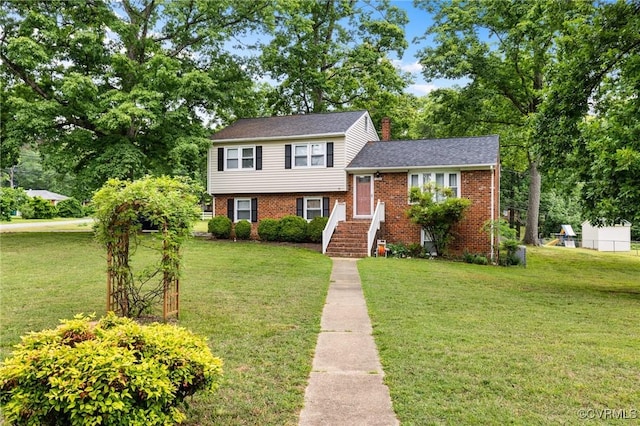 10970 Haverford Ln, North Chesterfield, VA 23236 - split level home featuring a front yard, brick siding, and a chimney