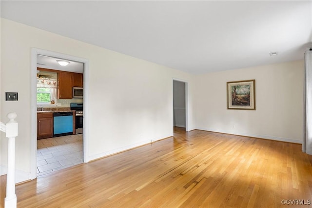 10970 Haverford Ln, North Chesterfield, VA 23236 - spare room featuring light wood-style floors, baseboards, and a sink