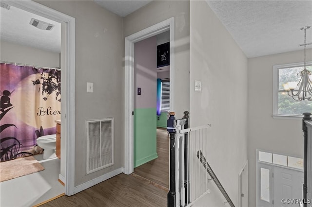14125 Mountain Rd, Glen Allen, VA 23059 - hall featuring an upstairs landing, a chandelier, wood finished floors, baseboards, and a textured ceiling