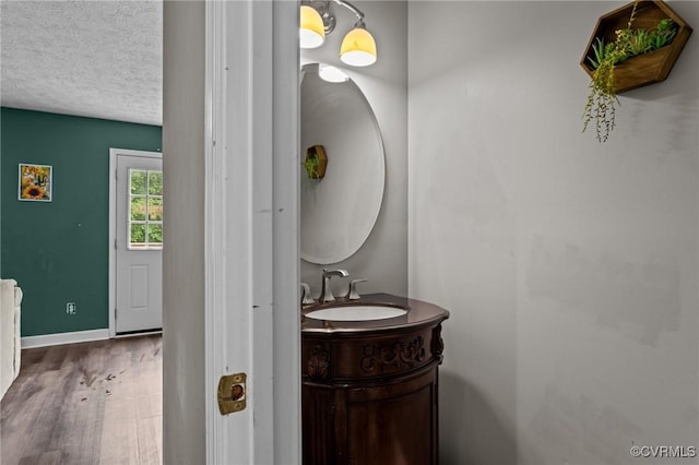 14125 Mountain Rd, Glen Allen, VA 23059 - bathroom with vanity, wood finished floors, baseboards, and a textured ceiling
