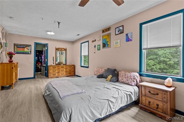 14125 Mountain Rd, Glen Allen, VA 23059 - bedroom featuring wood finished floors, a spacious closet, a closet, and a ceiling fan