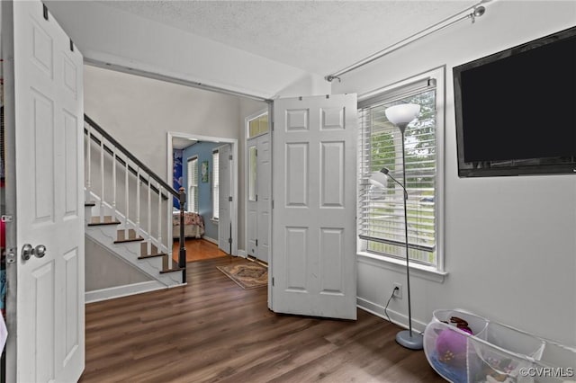 14125 Mountain Rd, Glen Allen, VA 23059 - foyer featuring healthy amount of natural light, a textured ceiling, wood finished floors, stairs, and baseboards