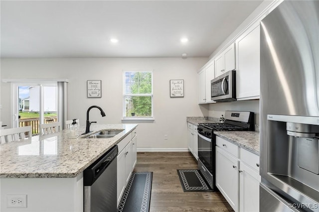 7007 Batten Ct, Chesterfield, VA 23234 - kitchen with appliances with stainless steel finishes, a sink, dark wood finished floors, an island with sink, and white cabinetry