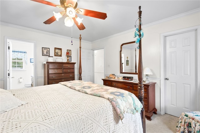 bedroom featuring crown molding, light colored carpet, a ceiling fan, and ensuite bathroom