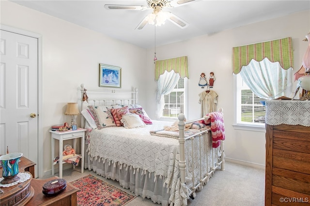 carpeted bedroom featuring baseboards and a ceiling fan