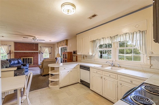 68 Family Ln, Cobbs Creek, VA 23035 - kitchen with dishwashing machine, a sink, a ceiling fan, and healthy amount of natural light