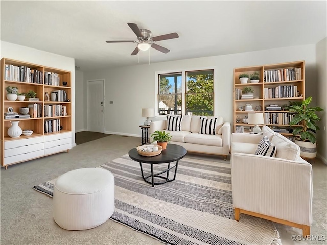 carpeted living room with ceiling fan and baseboards