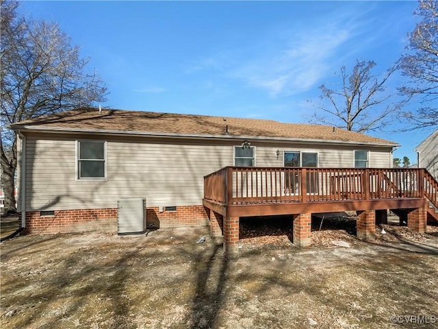 rear view of house with cooling unit, crawl space, a deck, and a shingled roof