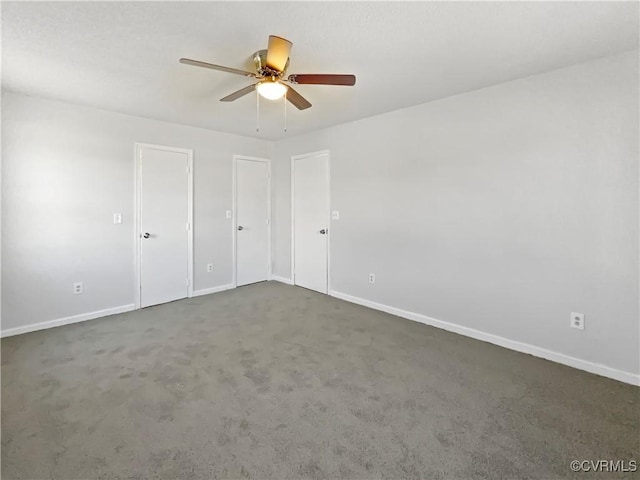 unfurnished bedroom featuring baseboards, carpet, and a ceiling fan