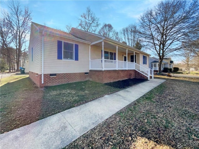single story home featuring a porch, crawl space, and a front lawn