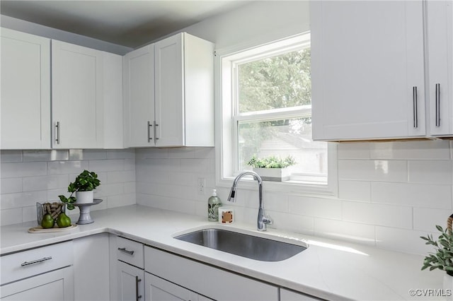 314 Maryland Ave, Hopewell, VA 23860 - kitchen with a sink, light countertops, white cabinetry, and backsplash