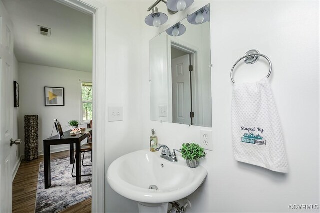 314 Maryland Ave, Hopewell, VA 23860 - bathroom with a sink, wood finished floors, and baseboards