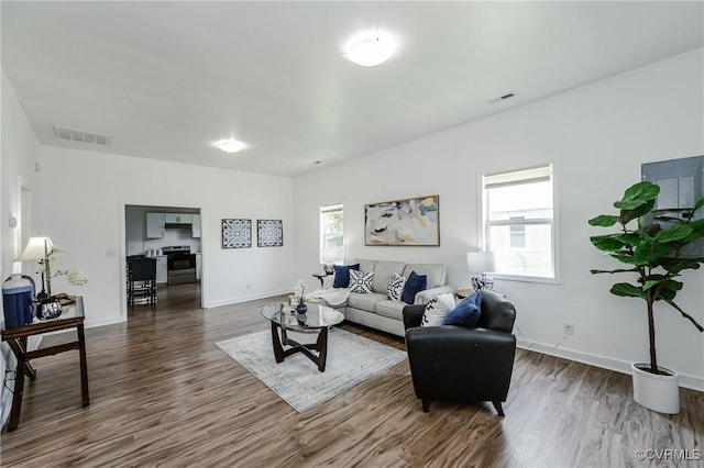 314 Maryland Ave, Hopewell, VA 23860 - living room with healthy amount of natural light, dark wood-type flooring, and baseboards