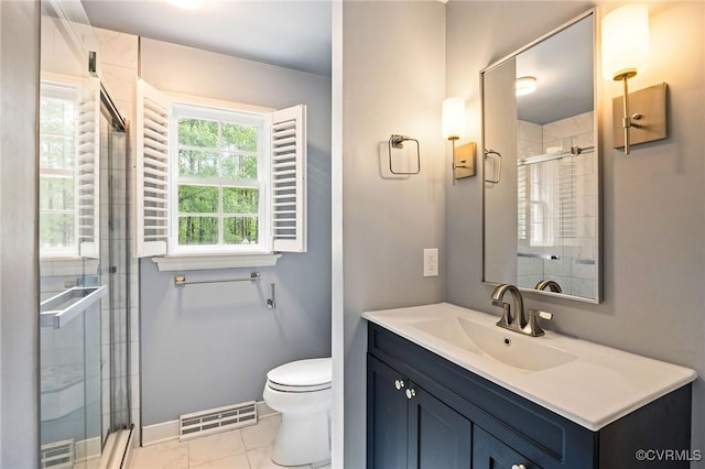 full bathroom with a stall shower, toilet, vanity, and baseboards