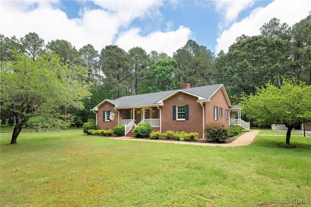 ranch-style home featuring covered porch, brick siding, a front lawn, and a chimney