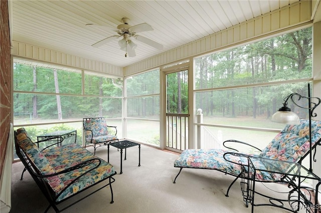 sunroom featuring ceiling fan and plenty of natural light