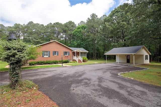 view of front of property featuring driveway, a front yard, and an attached carport
