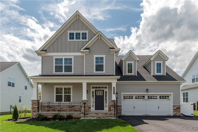 12543 N Readers Ln, Manakin Sabot, VA 23103 - craftsman-style home with a porch, board and batten siding, asphalt driveway, an attached garage, and stone siding