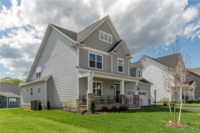12543 N Readers Ln, Manakin Sabot, VA 23103 - craftsman-style home featuring a porch, board and batten siding, cooling unit, a front yard, and a garage