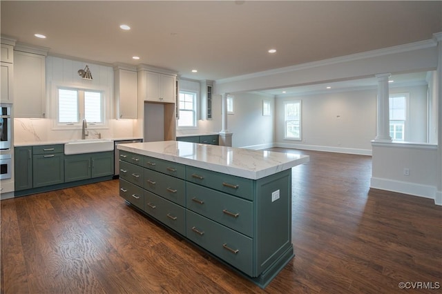12543 N Readers Ln, Manakin Sabot, VA 23103 - kitchen with green cabinets, a sink, decorative columns, crown molding, and recessed lighting