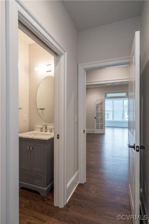 12543 N Readers Ln, Manakin Sabot, VA 23103 - corridor with dark wood-style flooring, baseboards, and a sink