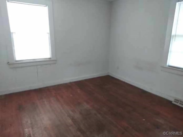 unfurnished room featuring wood finished floors and baseboards