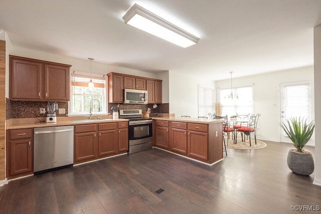 7418 Whirlaway Dr, Midlothian, VA 23112 - kitchen with stainless steel appliances, a sink, a peninsula, and dark wood-type flooring